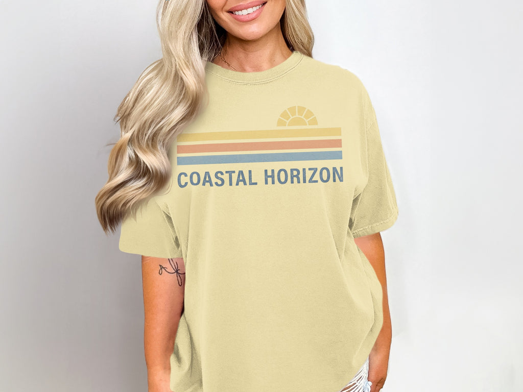 Yellow t-shirt with "Coastal Horizon" text and a stylized sun graphic.