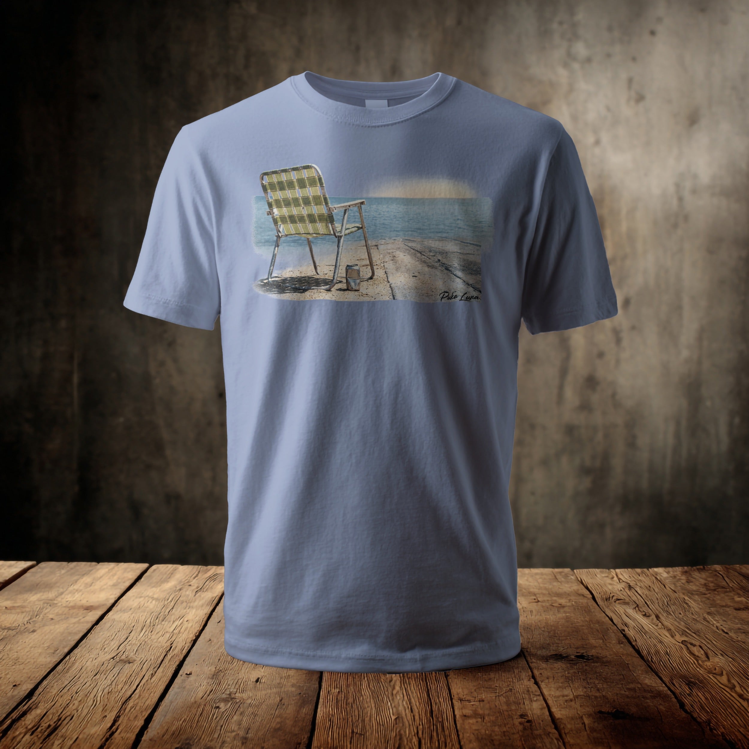 Light blue t-shirt displaying a serene dockside scene with a chair.