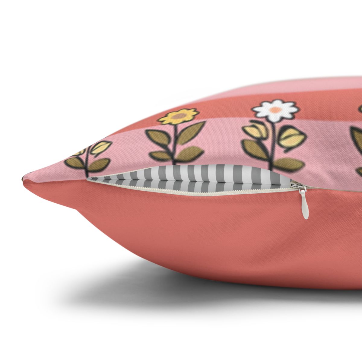 Coral throw pillow with a floral stripe pattern and visible zipper.