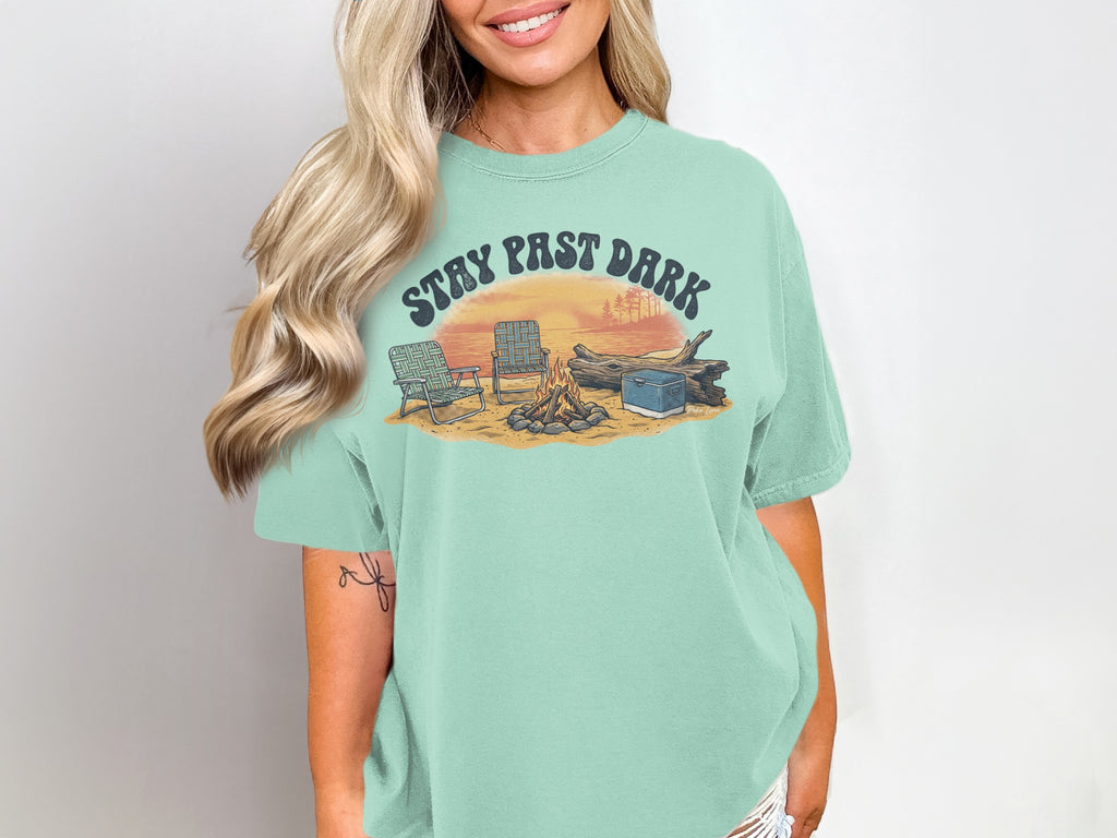 T-shirt with "STAY PAST DARK" text over a campfire scene with chairs and cooler.