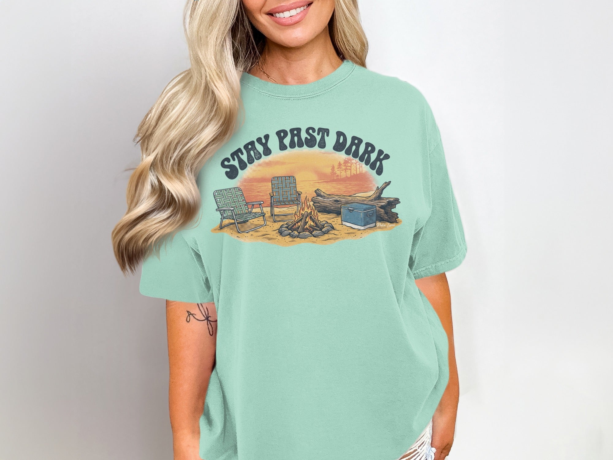 T-shirt with "STAY PAST DARK" text over a campfire scene with chairs and cooler.