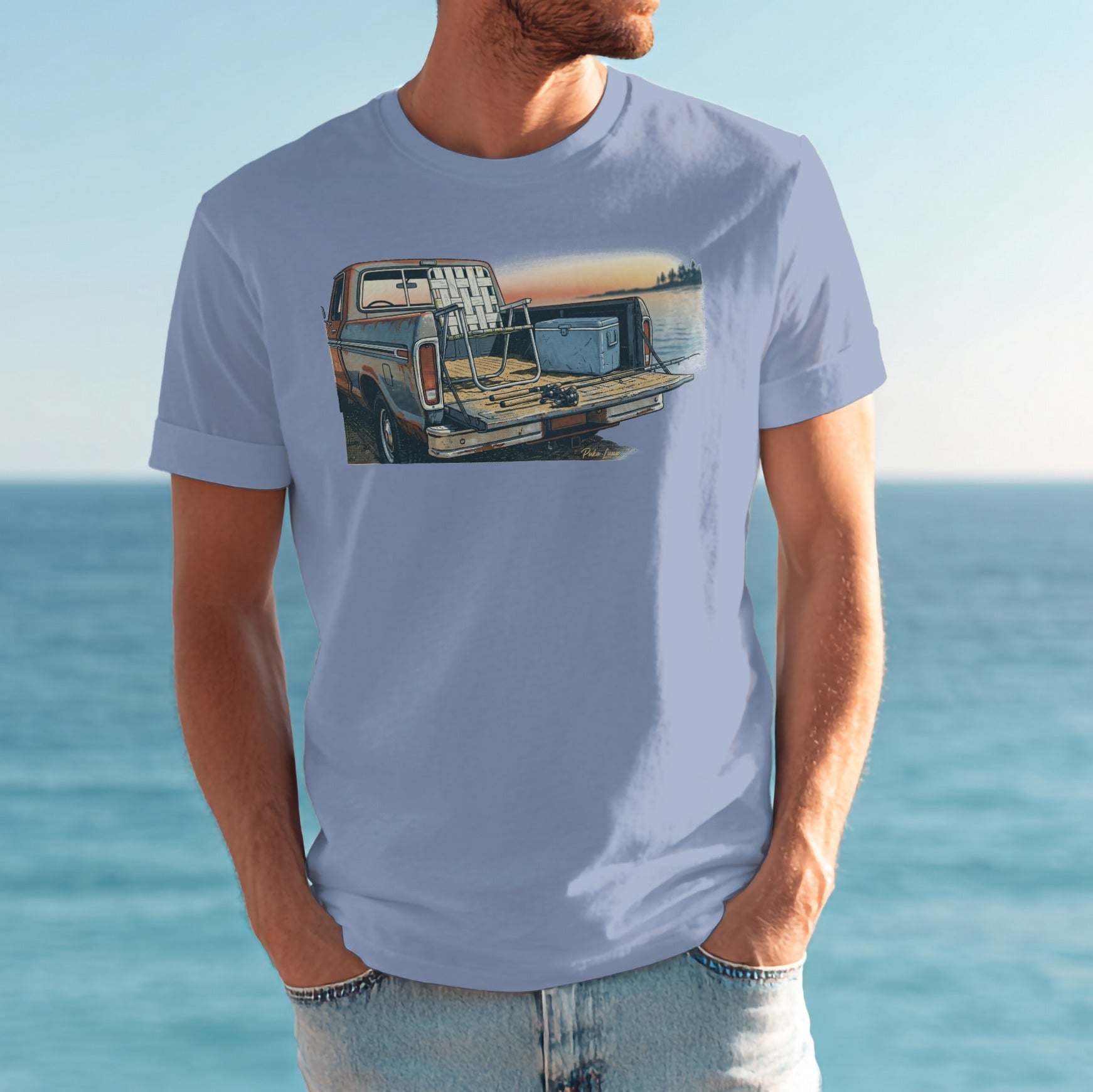 Light blue t-shirt featuring illustration of vintage pickup truck with cooler in bed, by water.