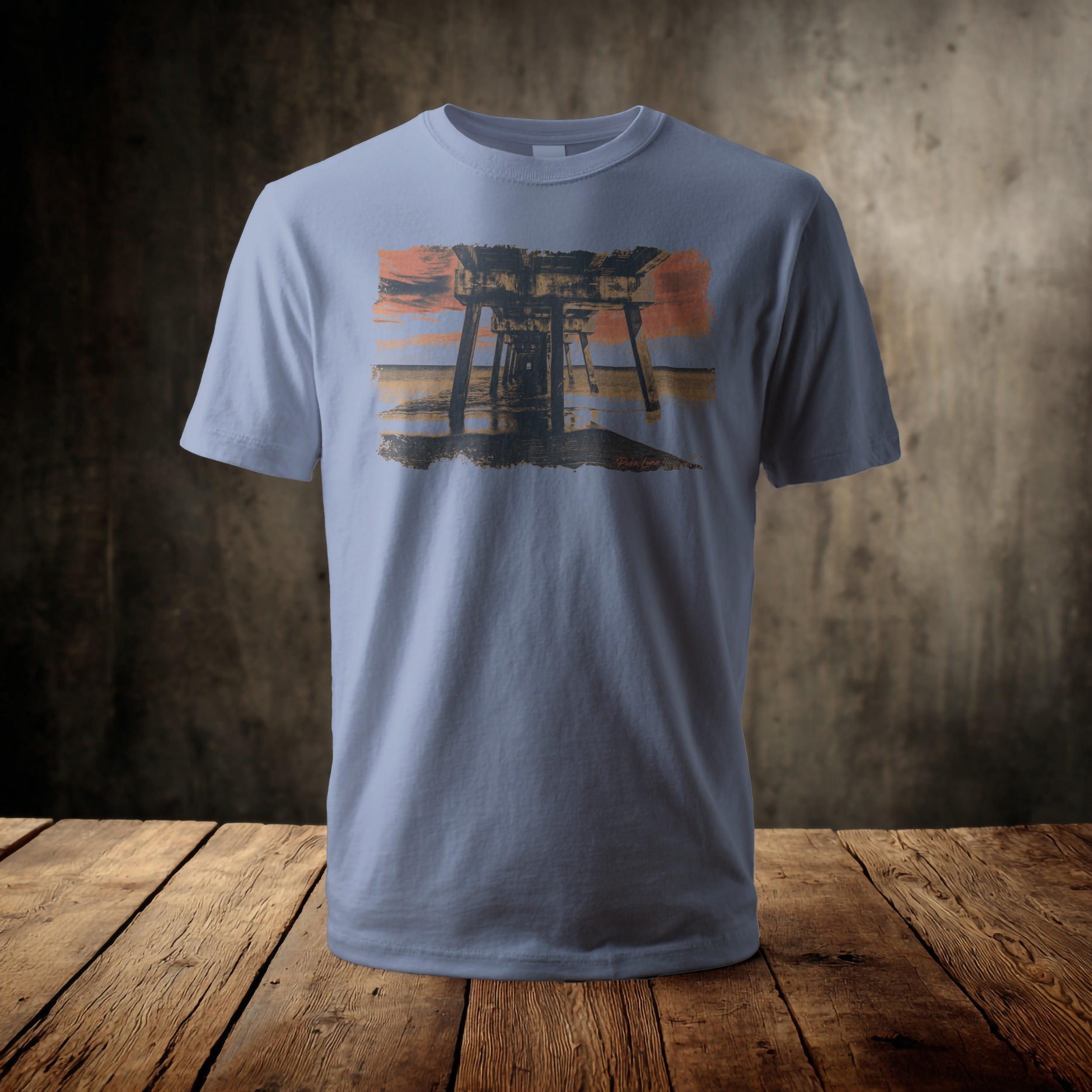 Light blue t-shirt with a sunset over a pier design.