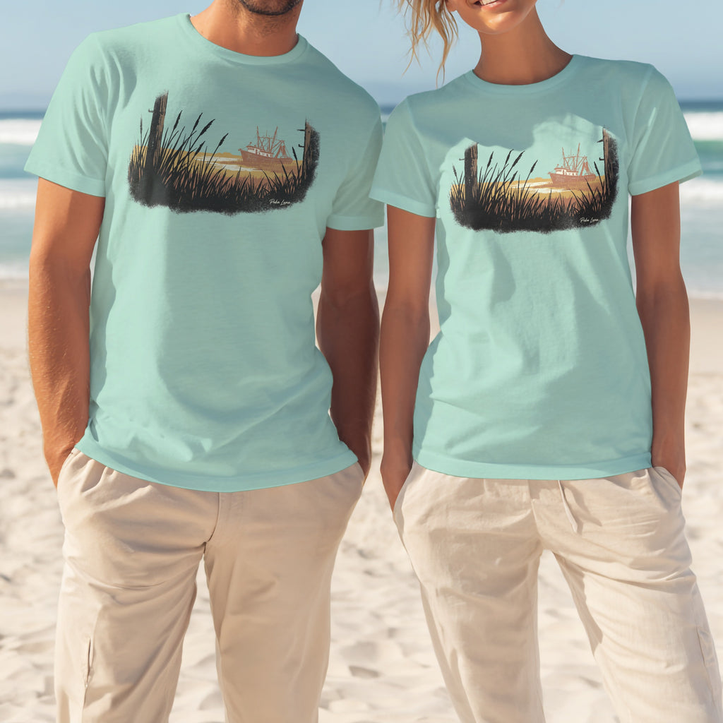 Two people wear light teal t-shirts with a sunset landscape graphic.