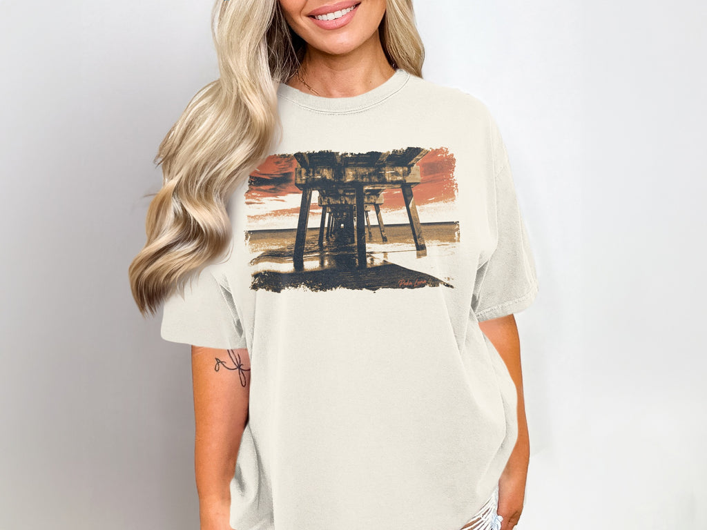 T-shirt with a watercolor print of a pier at sunset.