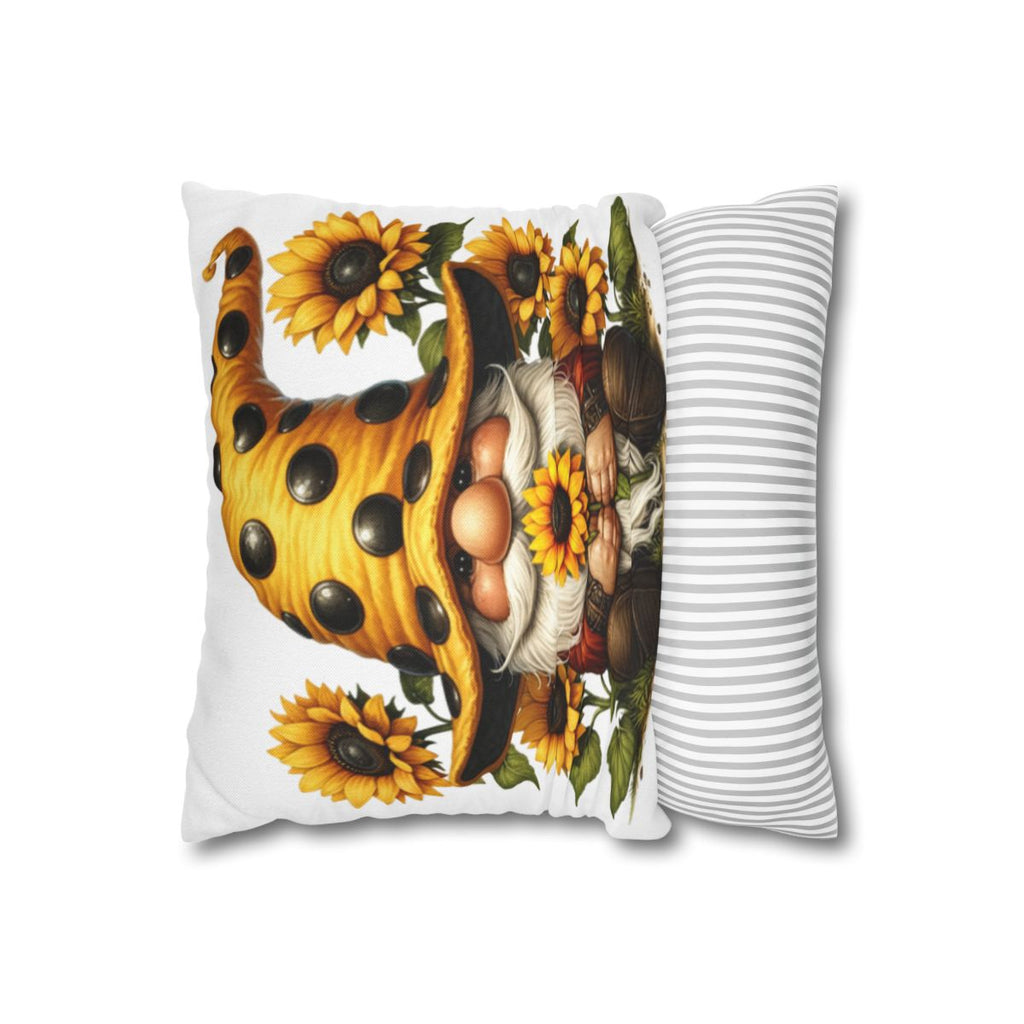 Gnome with sunflowers on a polka dot hat, next to a striped pillow.
