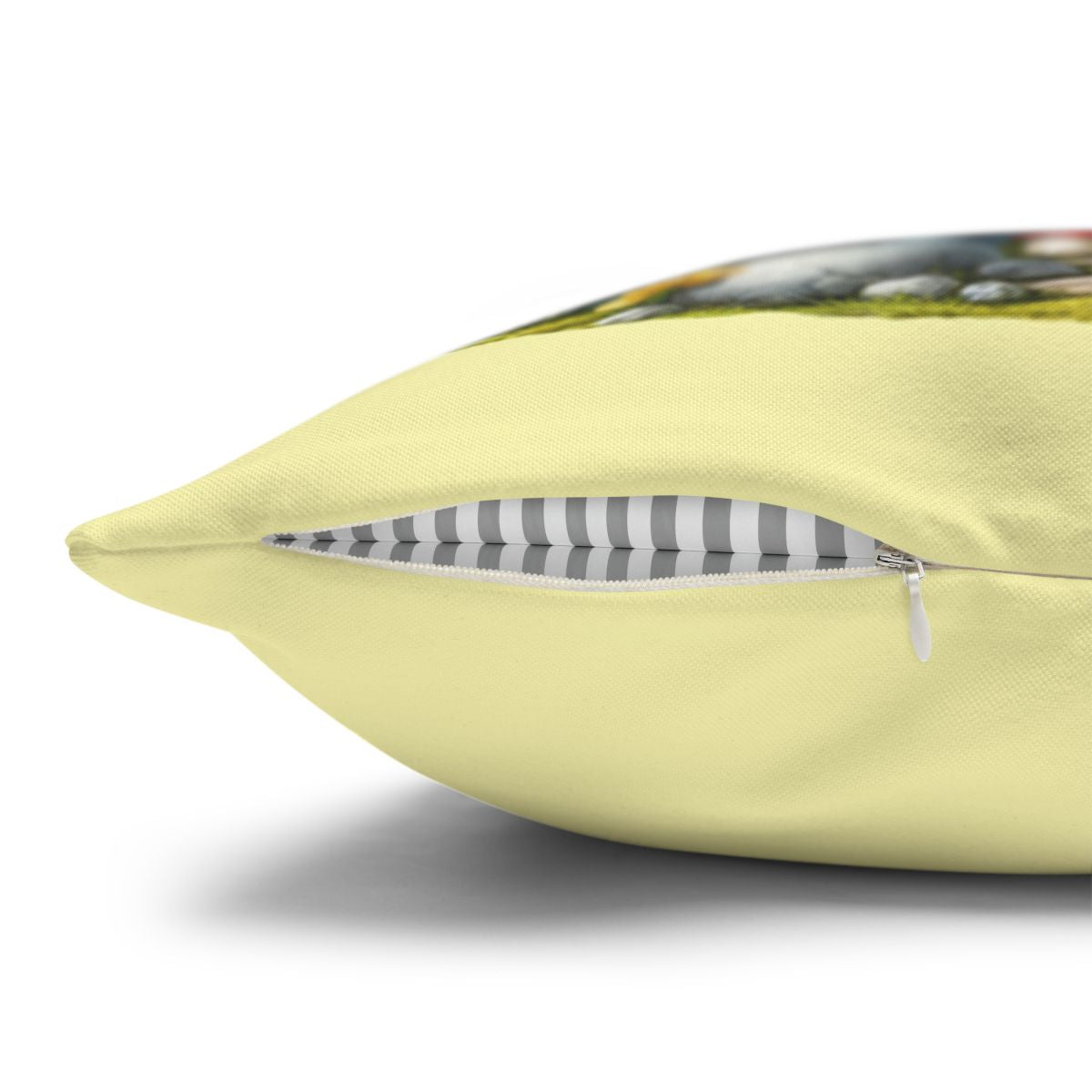 Light yellow pillow with open zipper revealing striped lining.