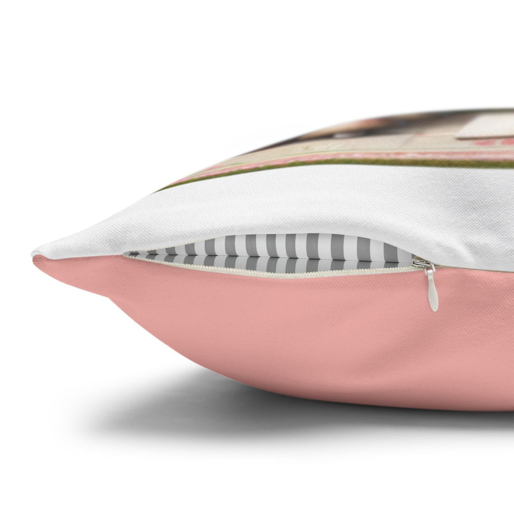Pink throw pillow with gray and white striped accent fabric and zipper closure.