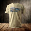 Tan t-shirt with a graphic of a truck bed filled with fishing gear by a lake.