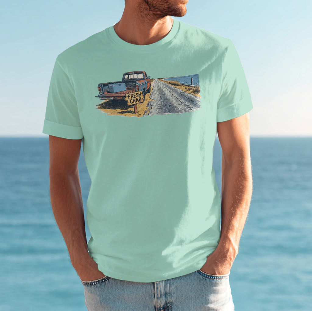 T-shirt featuring a vintage red truck on a coastal road with "FRESH CRAB" sign.