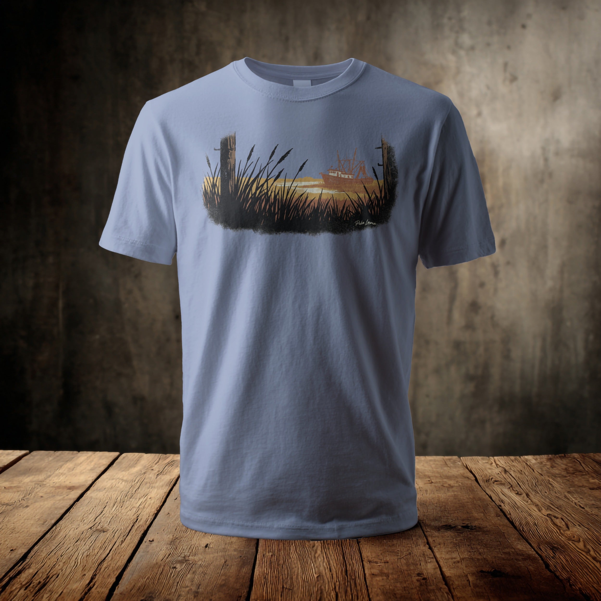 Light blue t-shirt with a printed graphic of a boat at sunset.