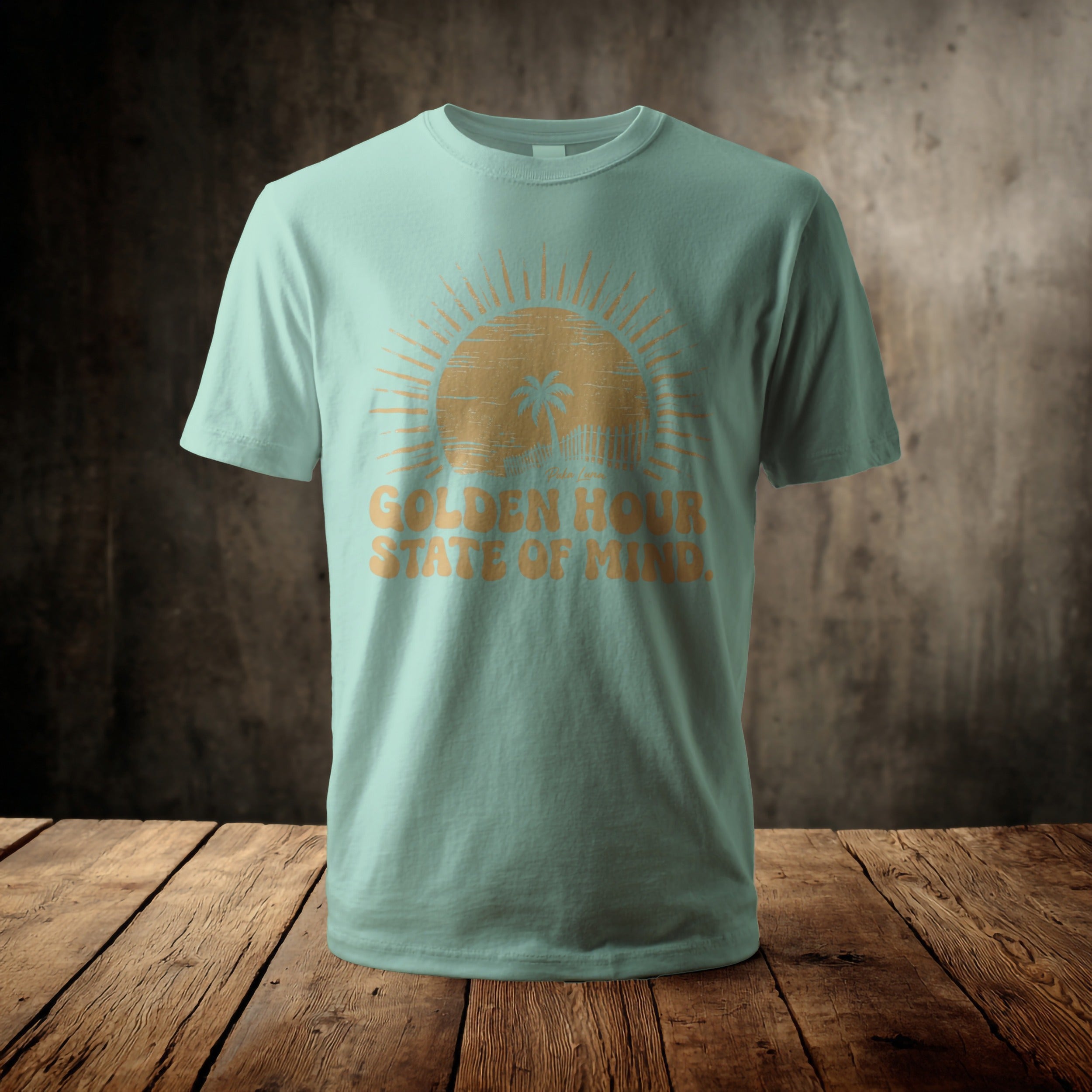 Pale blue t-shirt with a sun graphic and "Golden Hour State of Mind" text.