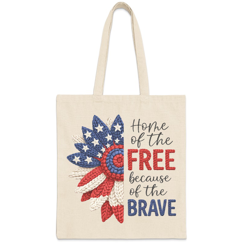 Canvas tote bag with crocheted American flag sunflower and "Home of the Free Because of the Brave" text.
