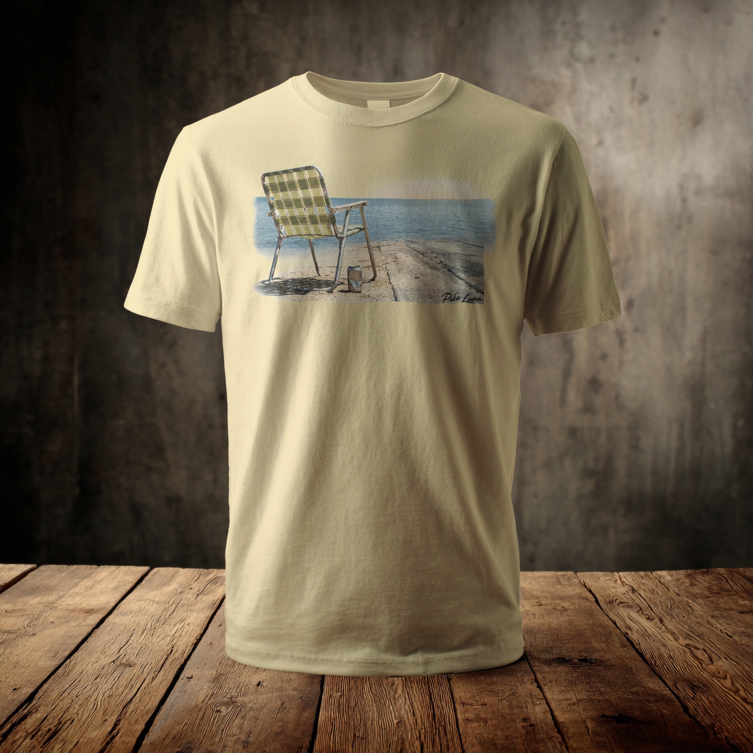 T-shirt with a graphic of a plaid chair by the water.