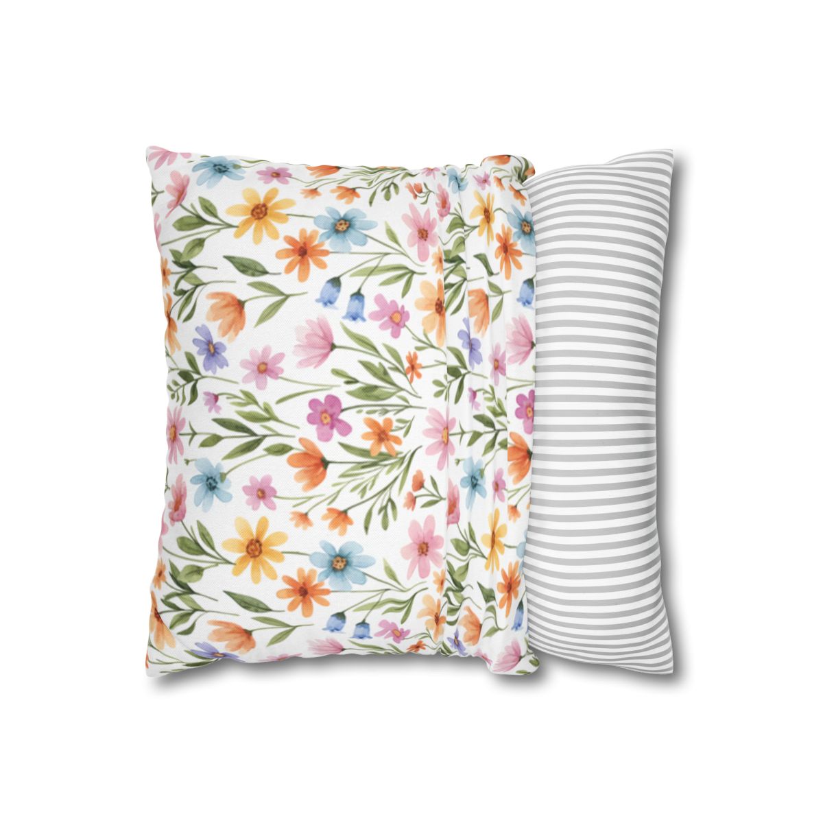 Two decorative pillows, one floral, one striped, against a white background.