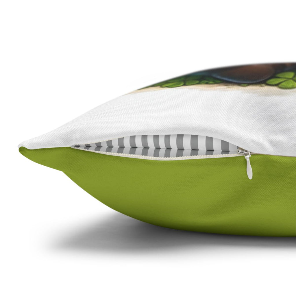 Green pillow with zipper detail and a bird illustration on white background.