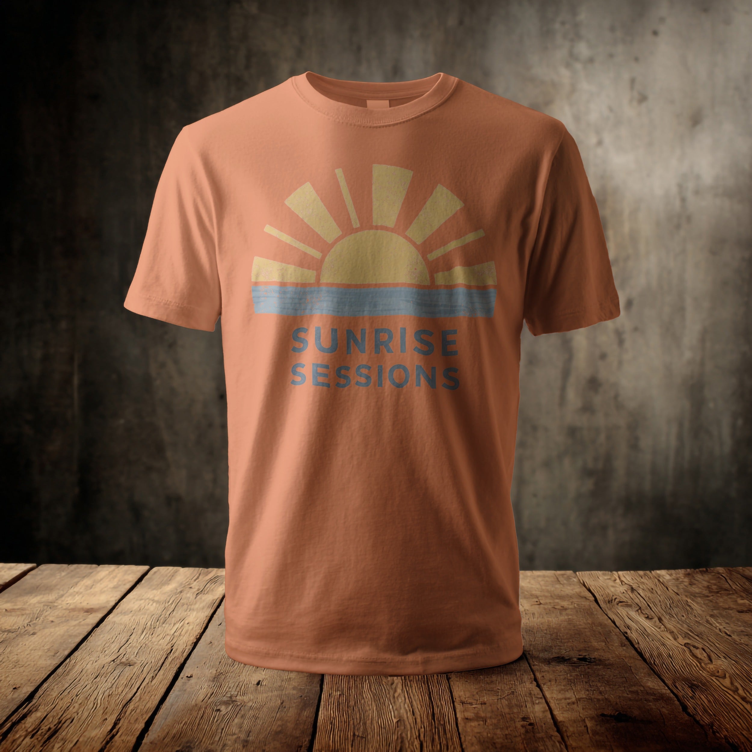 Orange t-shirt with a rising sun and "SUNRISE SESSIONS" text.