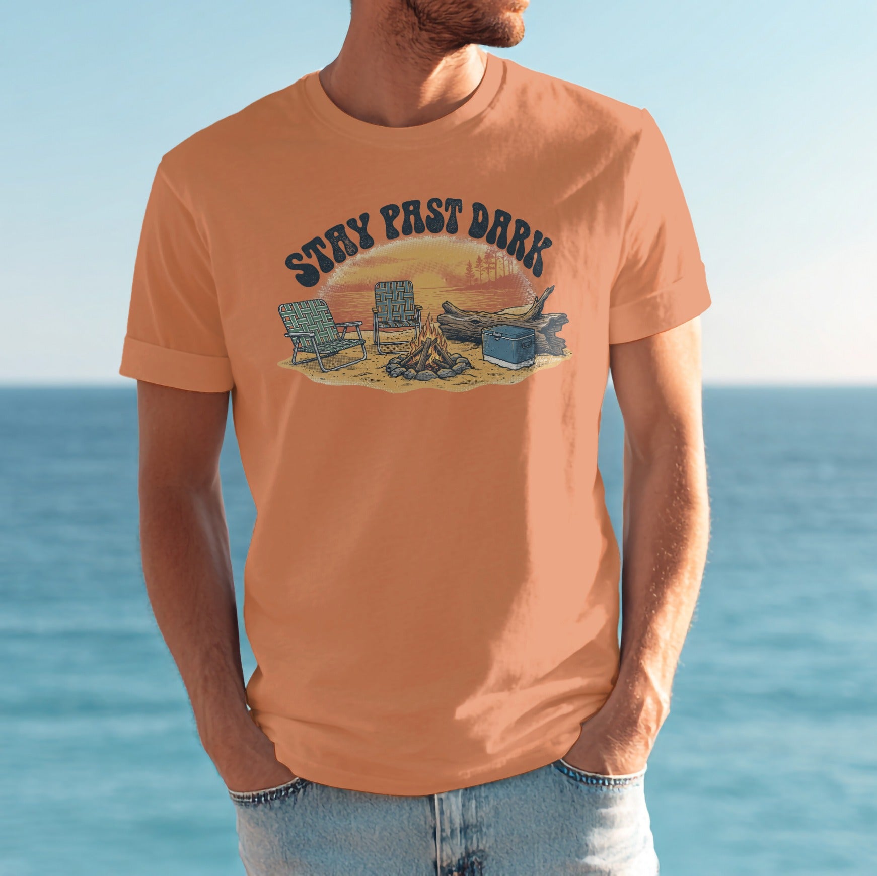 T-shirt with "Stay Past Dark" text over a beach camping scene.