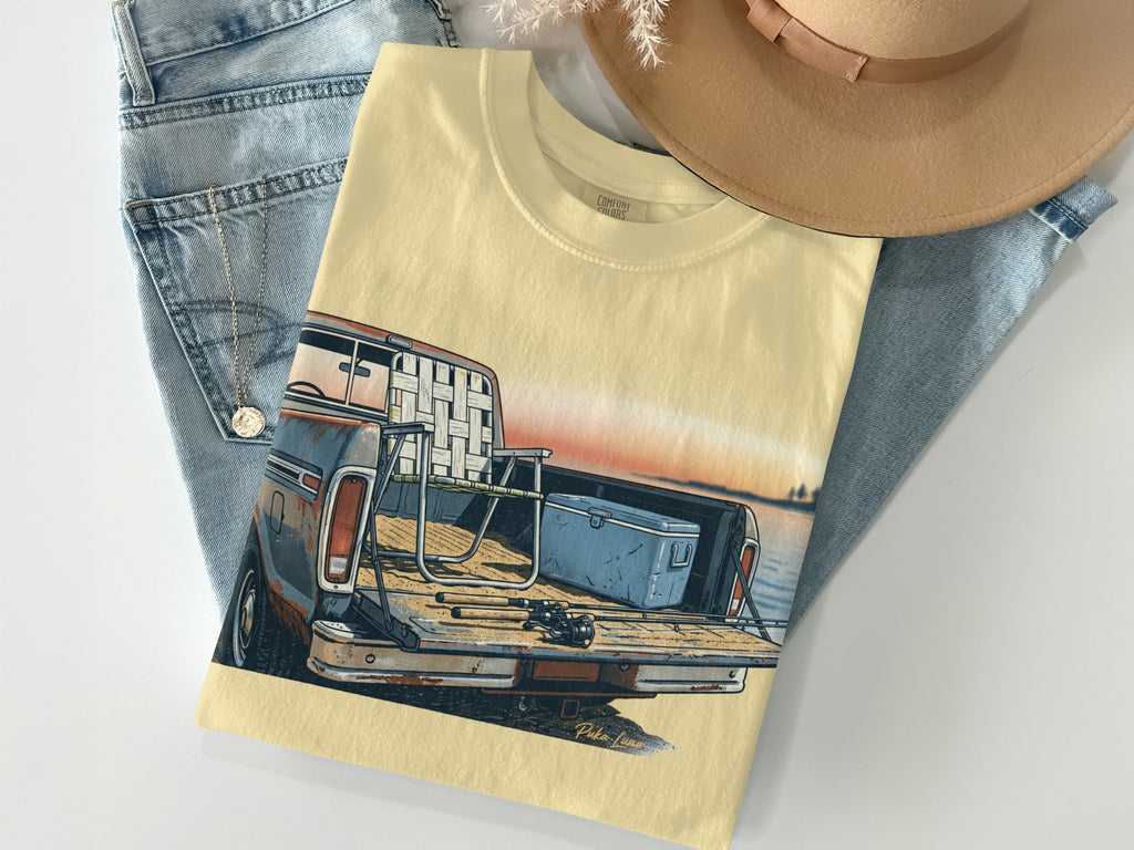 Pale yellow t-shirt with a vintage truck and fishing gear illustration.