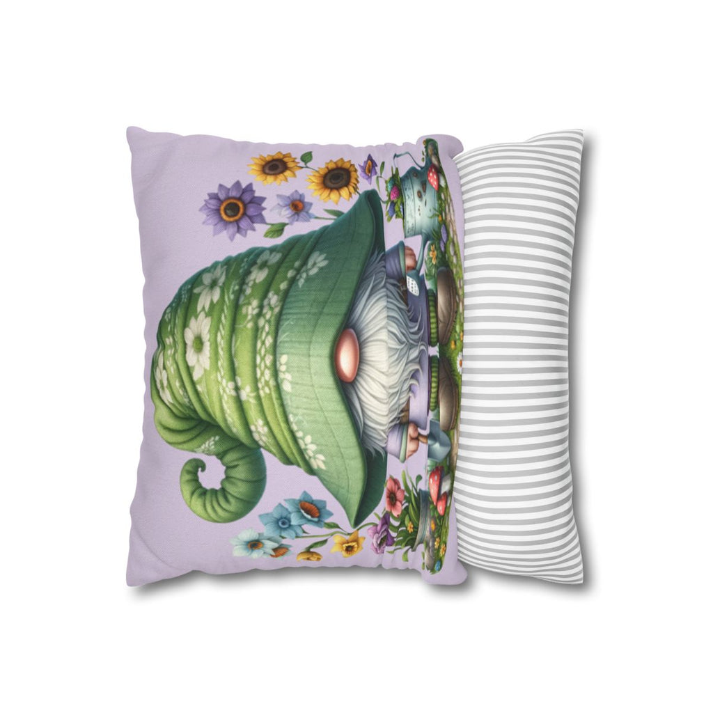 Gnome with green hat and flowers on a purple pillow with striped pillow behind.