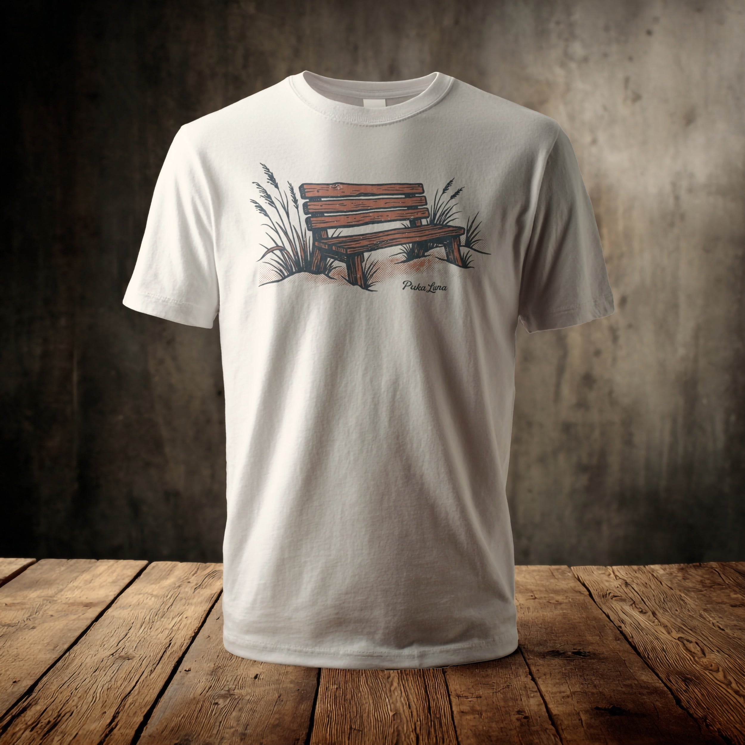 White t-shirt with graphic of wooden park bench and grass.