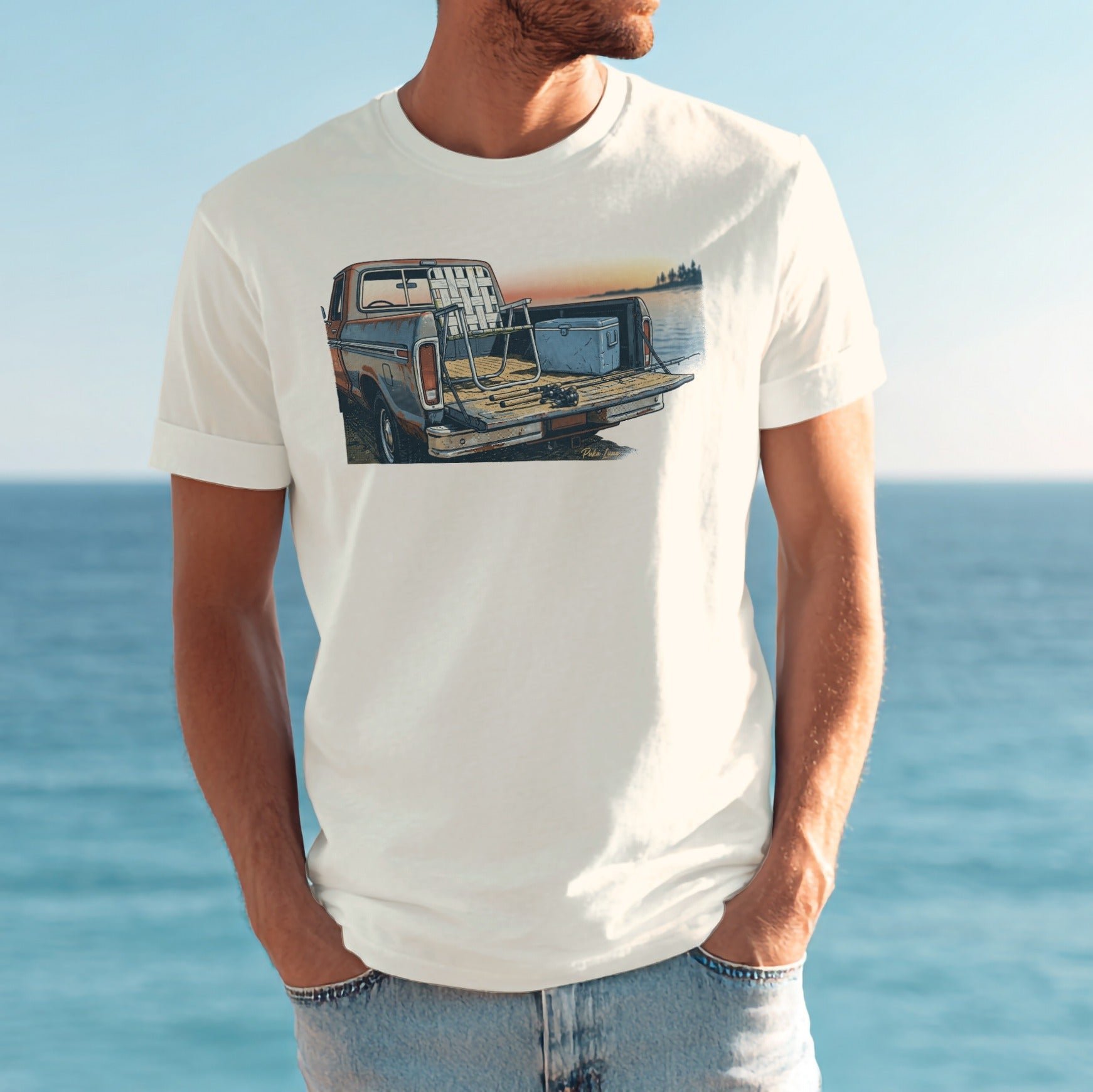 T-shirt graphic of a vintage truck at sunset with cooler and chairs in bed.