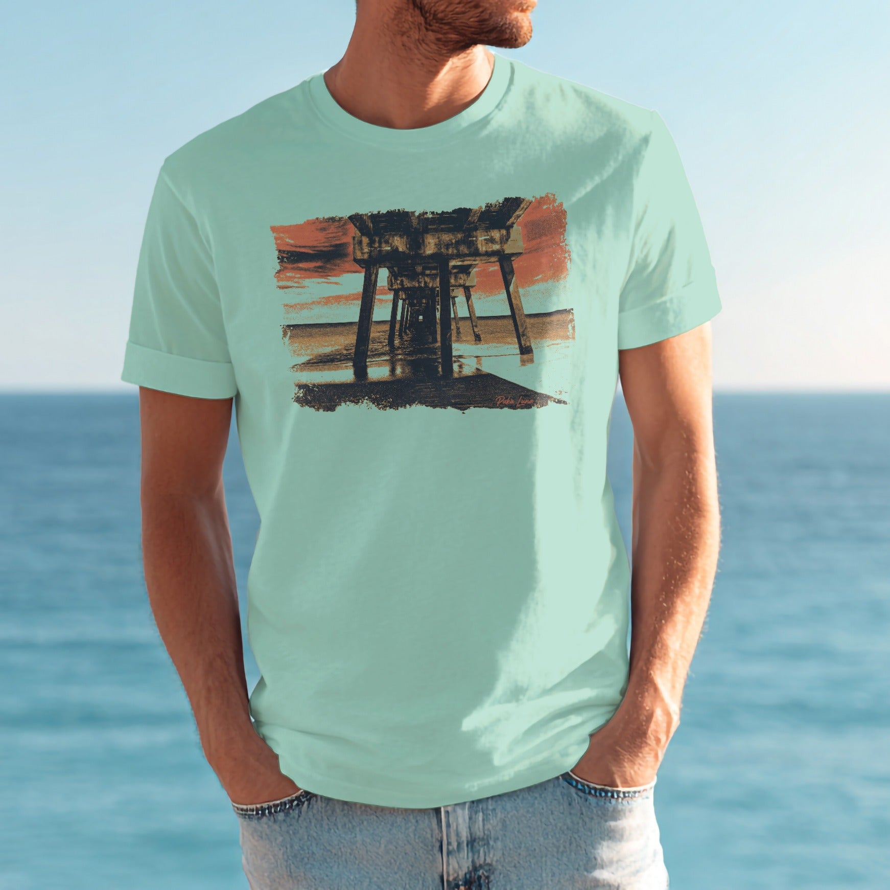 Light blue t-shirt with graphic of wooden pier over water.