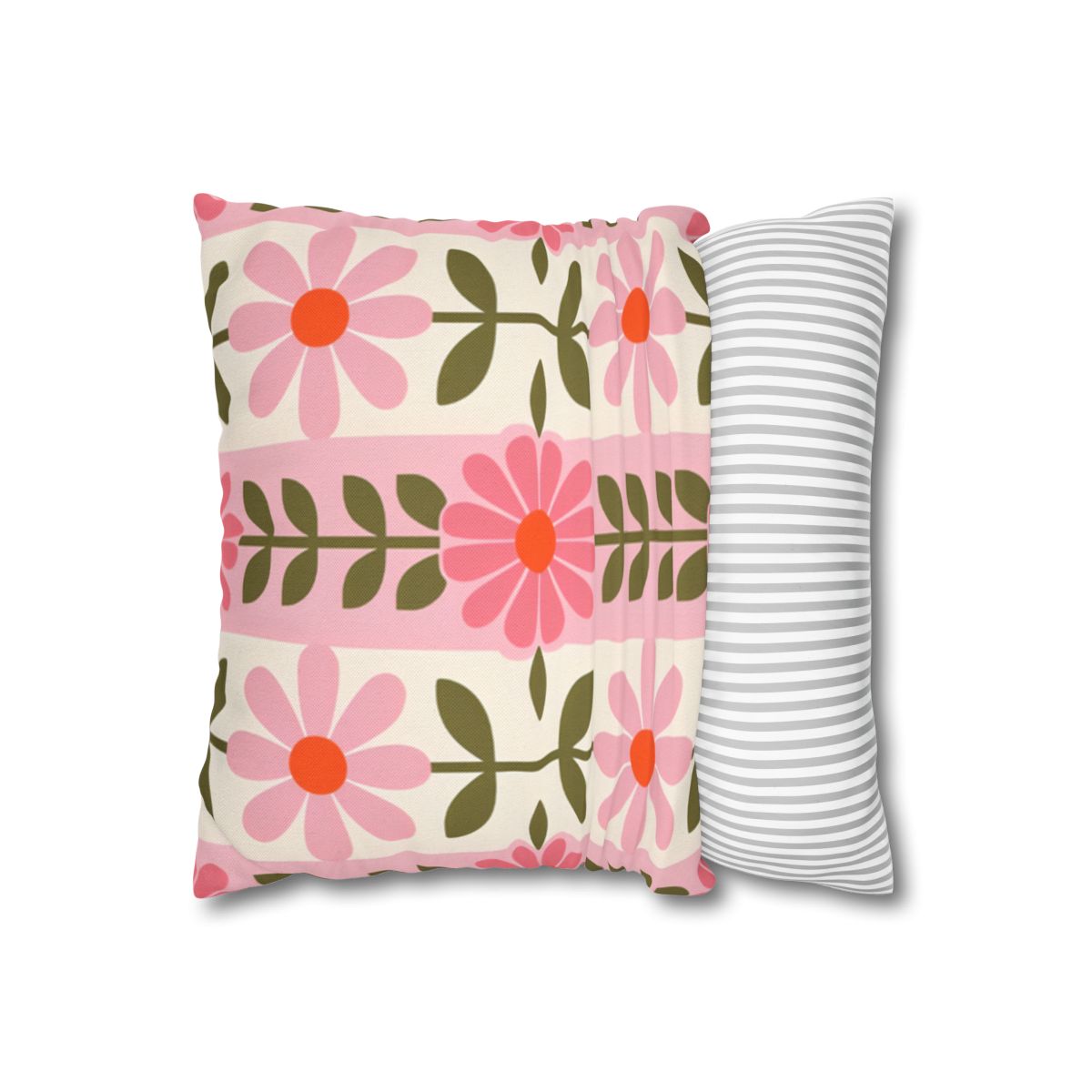 Pillow with pink floral pattern and striped pillow beside it.