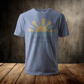 Light blue t-shirt with "Sunrise Sessions" text and a sun rising over water graphic.