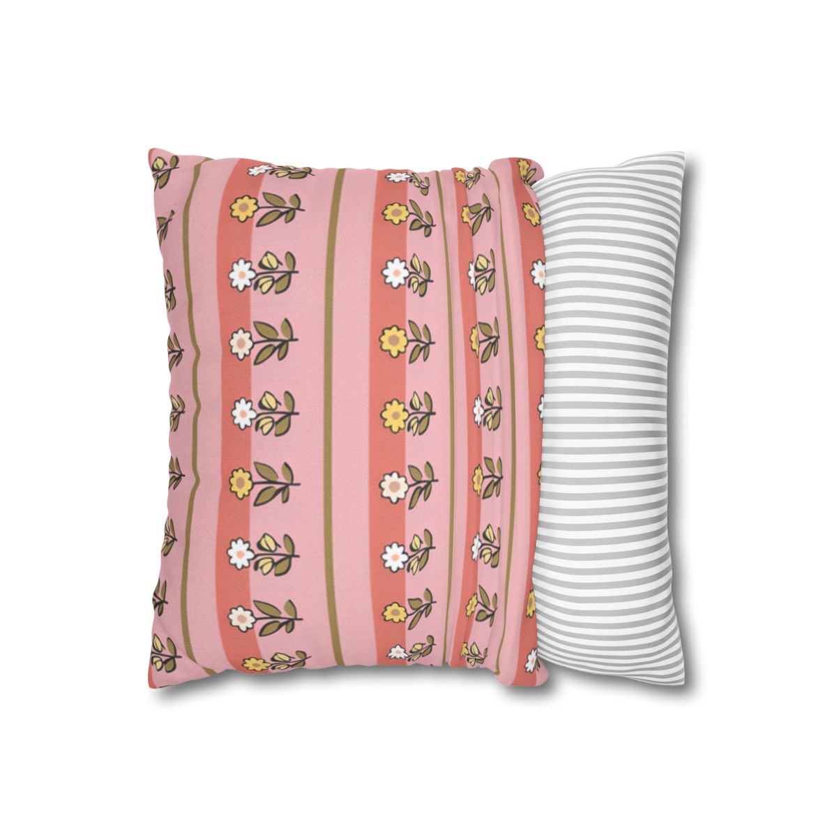 Pink floral pillow with striped pillow beside it.