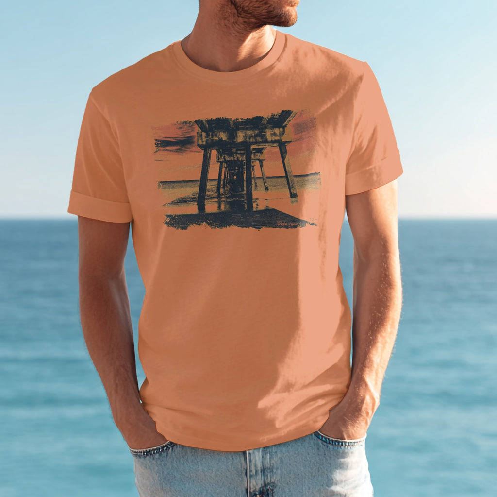 Man wearing orange t-shirt with sunset pier graphic.