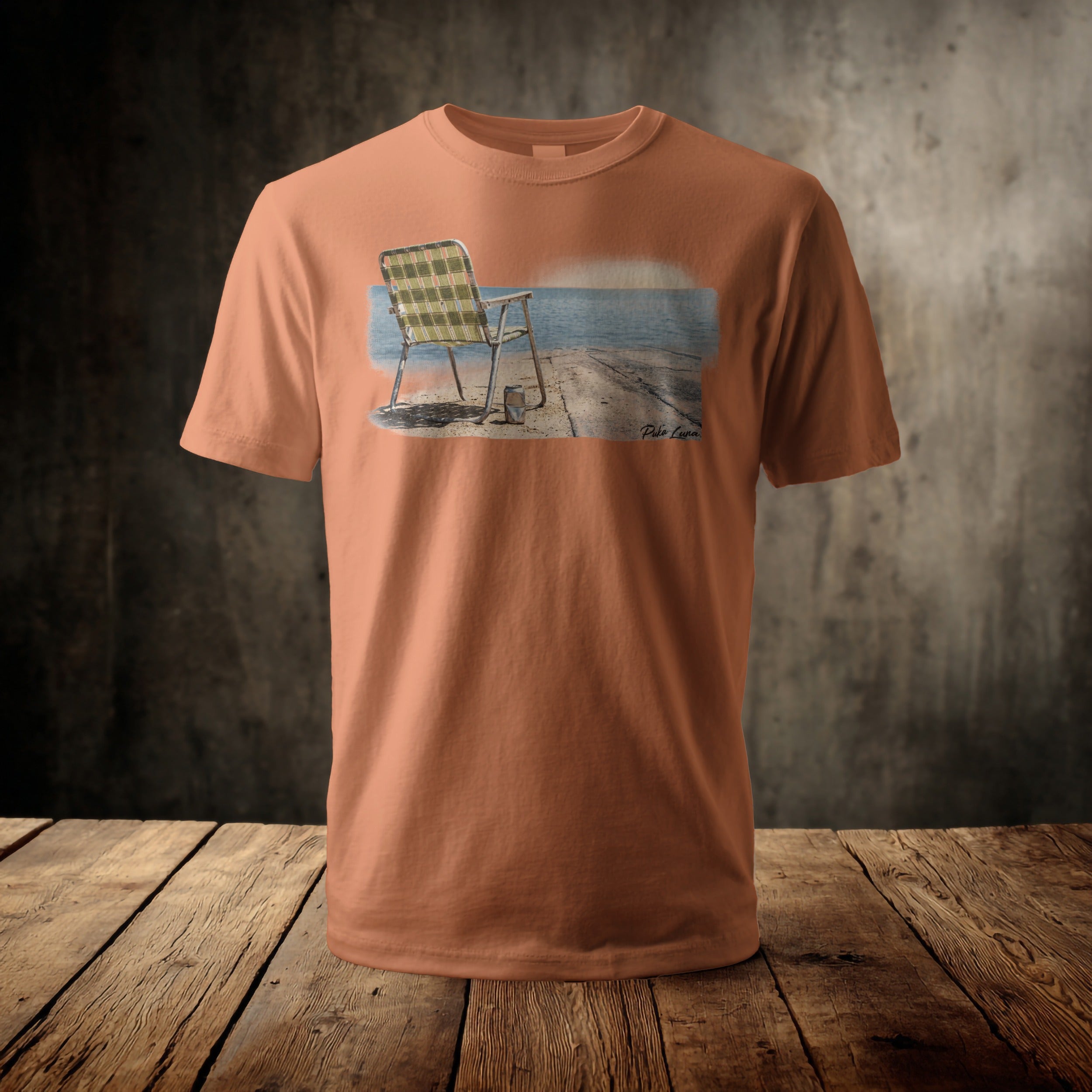 Orange t-shirt featuring a graphic of a checkered chair on a pier.