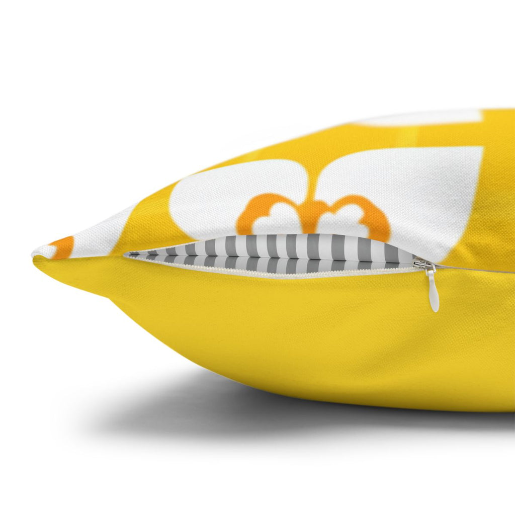 Yellow throw pillow with white floral pattern and gray striped piping.