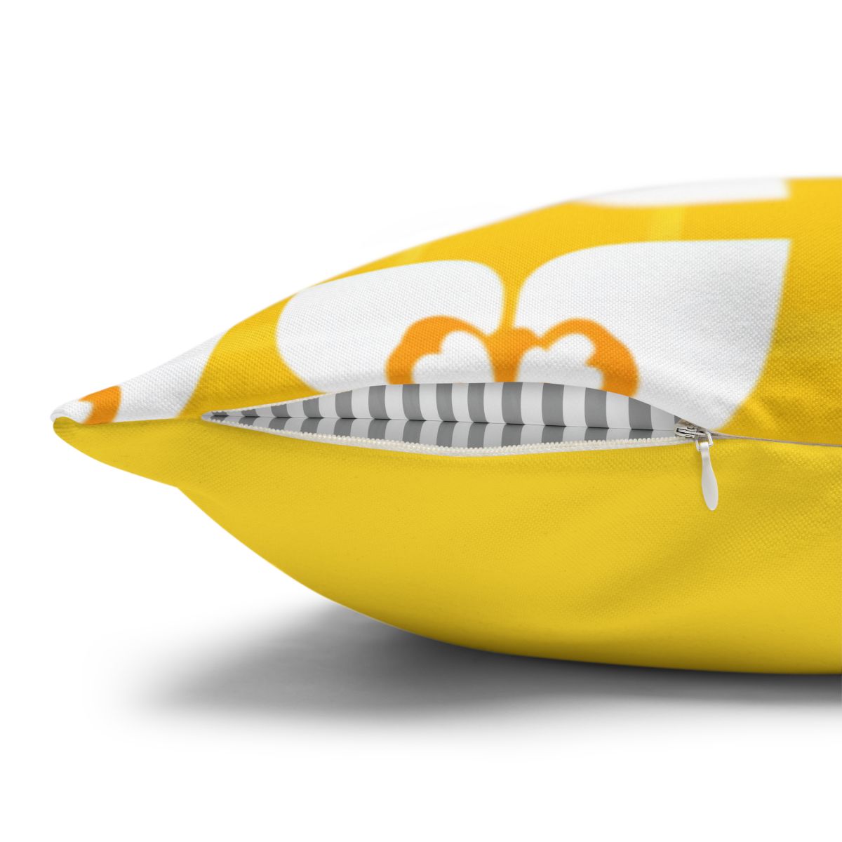 Yellow throw pillow with white floral pattern and gray striped piping.