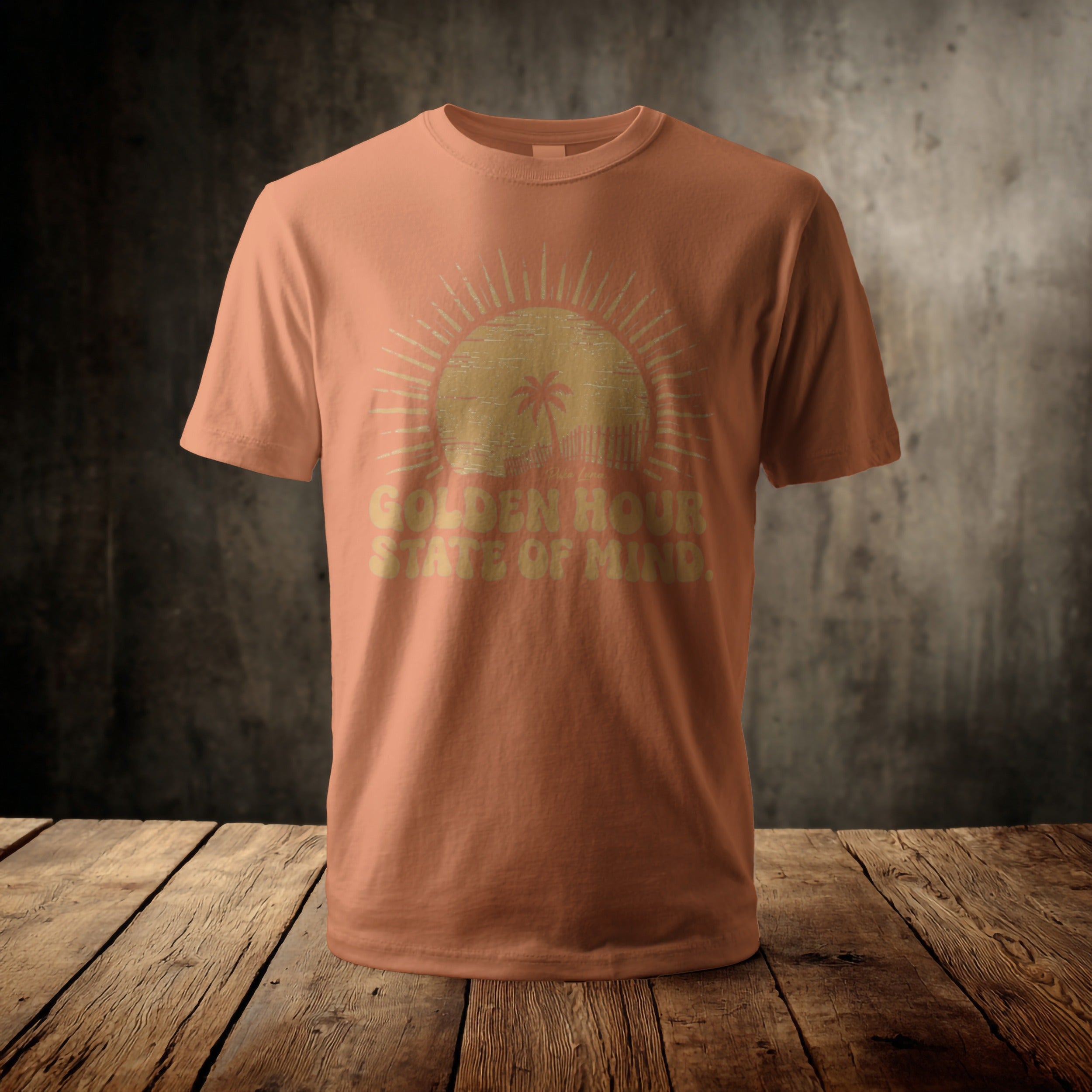 Coral t-shirt with distressed sun graphic and "Golden Hour State of Mind" text.