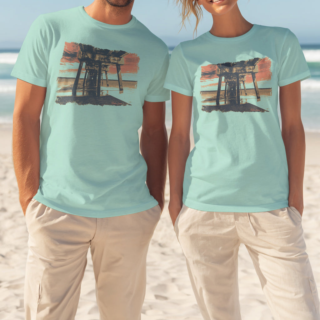 Two models wear light blue t-shirts featuring a wooden pier at sunset.